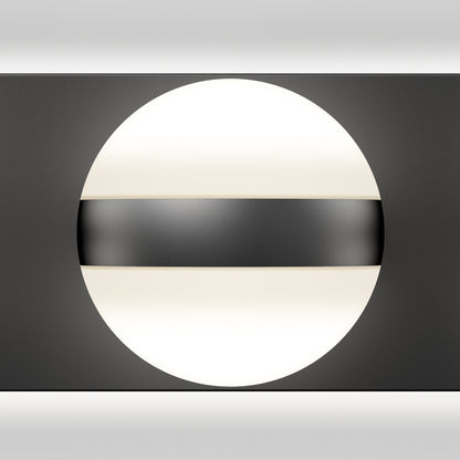 The Artika Baldric LED modern bathroom vanity light 3 CCT features a circular white light partially covered by a horizontal black band, adding a sleek touch to any minimalistic black and white decor.
