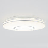 A modern, round ceiling light fixture with a white and silver design, emitting a bright, even glow against a plain light gray ceiling.