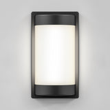 A modern rectangular wall sconce with a black frame and a frosted white curved light diffuser, mounted on a light gray wall.