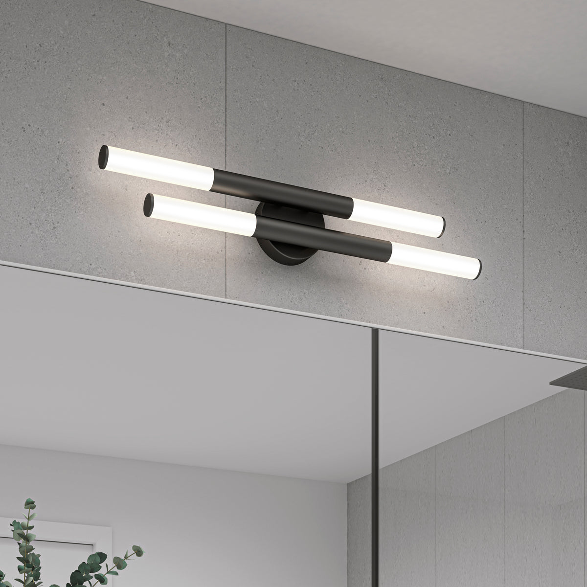 Modern wall-mounted light fixture with two horizontal black bars, each with white cylindrical ends, installed above a bathroom mirror on a gray tiled wall. Part of a plant is visible in the lower left corner.