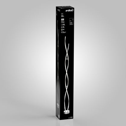 A tall, rectangular black box displays a photo of the Swirl modern LED floor lamp on the front. The Artika brand name appears at the top, with product details and icons in white text on the black background.