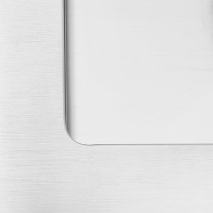 Close-up of the Artika Plaza Bar Single Bowl Sink’s brushed metal surface with a rounded rectangular cutout, showing a smooth, white reflective area inside.