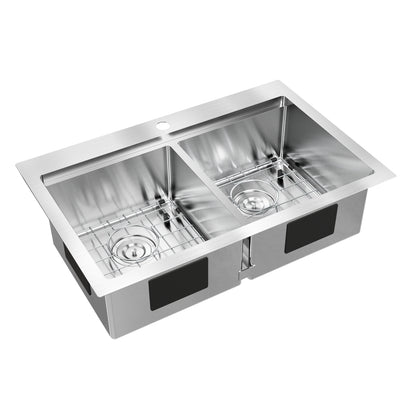 The Artika Newport double bowl stainless steel sink features a single faucet hole and includes metal grid racks for each basin.