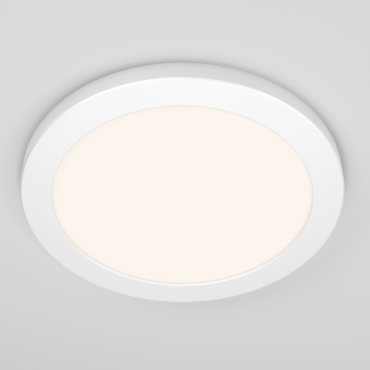 A round, white LED ceiling light fixture with a soft, diffused glow, mounted on a plain, light gray ceiling.