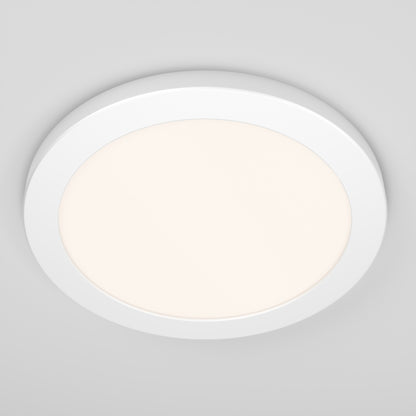 The Artika Europa Disk 9 in. LED modern flush mount light, with selectable 3 CCT, is installed on a smooth, light grey ceiling and emits a soft, even glow.