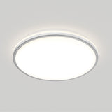 A round, white ceiling light fixture is mounted on a plain light gray ceiling, emitting a soft, even glow.