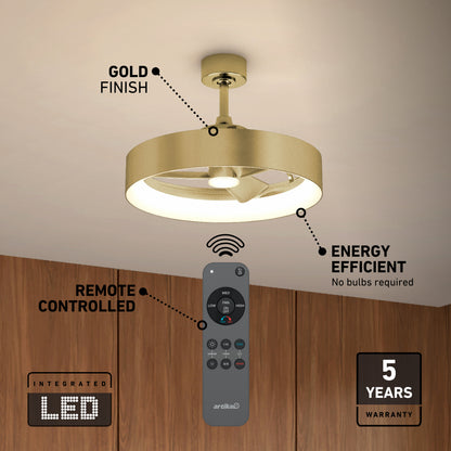 Ceiling fan with a gold finish and integrated LED light, mounted on a white ceiling above wooden cabinets. Features include remote control, energy efficiency, and a 5-year warranty.