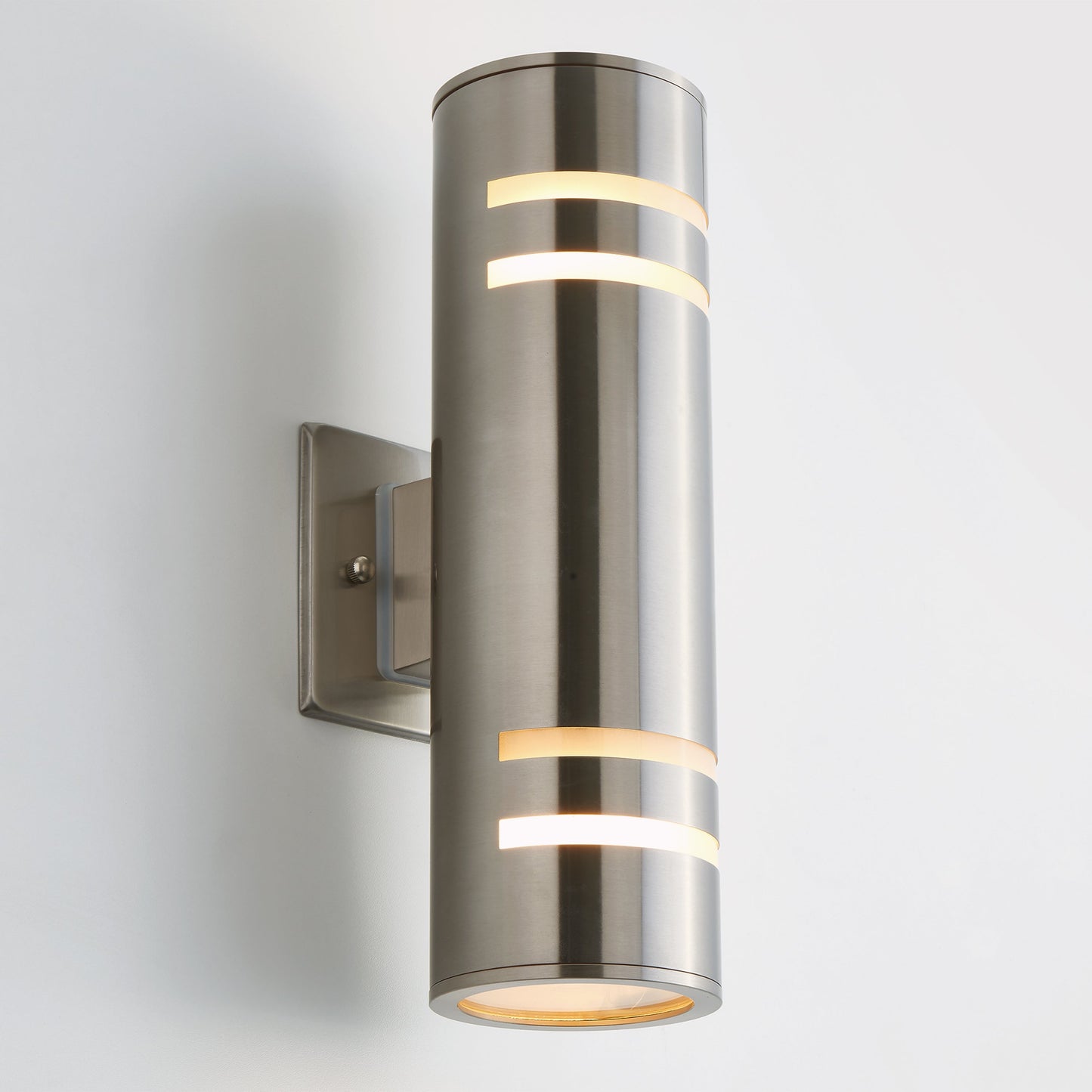 The Voltz indoor/outdoor wall light by Artika-CAN-dev features a modern black brushed metal cylindrical design with horizontal cutouts, mounted on a rectangular base—an elegant outdoor lighting solution.
