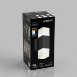 Box packaging for an Artika Lenox wall light, showing a modern black and white rectangular fixture, product details, energy efficiency icons, and photos of the light installed indoors.