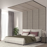 Modern bedroom with a low beige bed, mauve and beige pillows, a green blanket, a striped accent wall extending onto the ceiling, gray curtains, a potted plant, and a nightstand with books and a lamp.