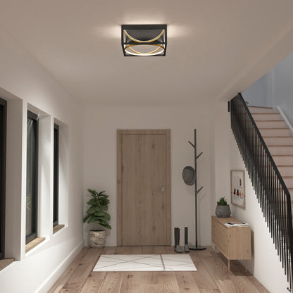 Modern entryway with wooden door, coat rack, plant, table, stairs, and Artika Luxury 13 in. Modern LED flush mount ceiling light.