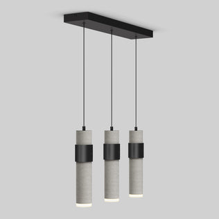 The Artika Barden 3-light LED pendant features three cylindrical concrete lampshades suspended from a black rectangular ceiling mount by slim black cords, shown here against a plain light gray background.