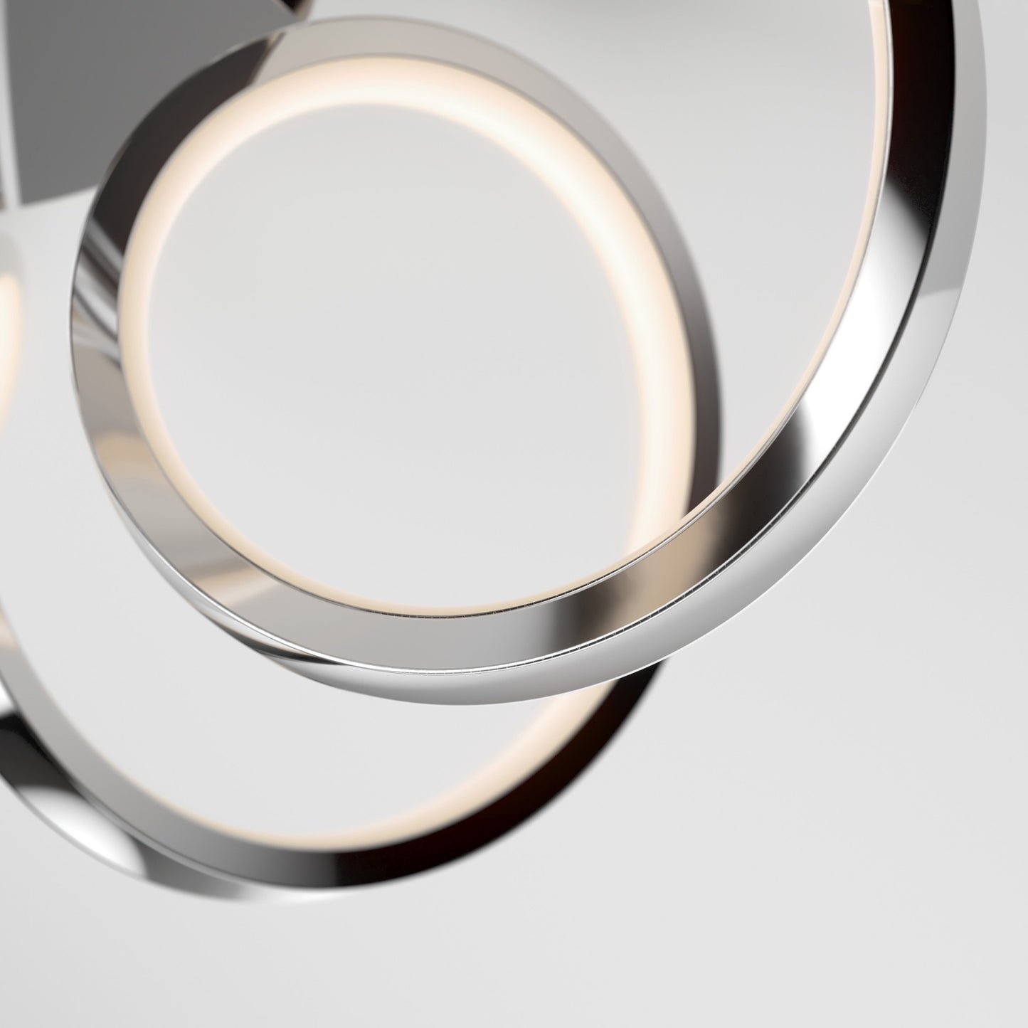 Close-up of two intertwined Swirl Ribbon LED pendant lights by Artika-CAN-dev, featuring a modern chrome finish. The integrated LEDs emit a soft, even glow against a plain background.
