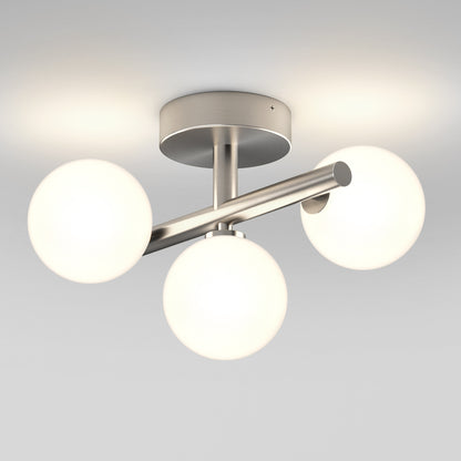 The Artika Bloom LED flush mount features three frosted glass globes on a brushed metal base, installed on a white ceiling to provide soft, warm light.