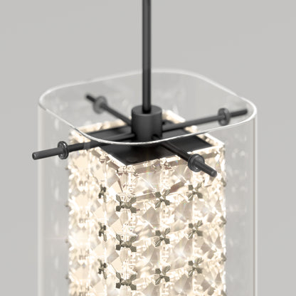 The Artika Crystal Cube 1-light LED pendant features a clear glass shade, a geometric crystal inner design, and black metal fittings, all illuminated to emit a soft glow.