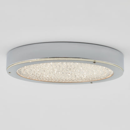 The Artika Glitter LED flush mount is a modern, circular ceiling light with a chrome finish and a central textured, sparkling diffuser, installed on a white ceiling.