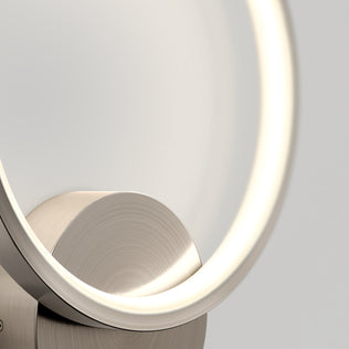 Close-up of the Artika Solis modern LED indoor-outdoor wall light 5 CCT, featuring a glowing circular design with a brushed metal base—ideal accent lighting for contemporary spaces against a neutral background.