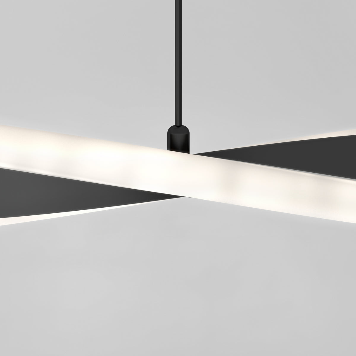 The Artika Finley Linear LED pendant light 3 CCT features two elongated, intersecting bars suspended from a black cord against a light gray background, showcasing a modern and minimalist design.