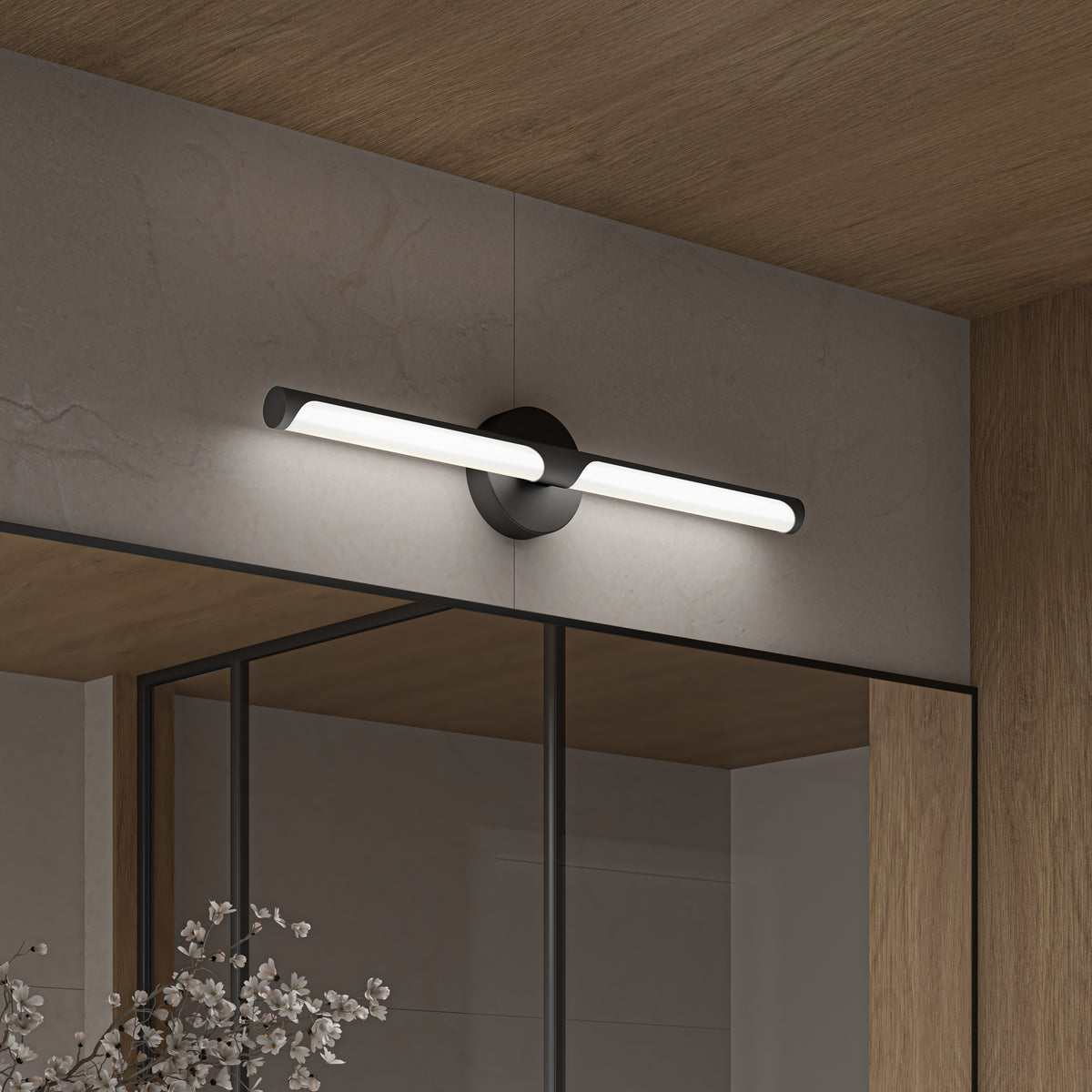 A modern, wall-mounted black and white LED light fixture is installed above a large mirror with a wooden frame, reflecting part of a contemporary interior with light-colored walls and ceiling.