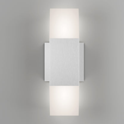 The Artika Lennox indoor-outdoor LED wall light 3 CCT features a modern brushed metal rectangular center with two frosted glass shades above and below, casting soft white light against a light gray backdrop.
