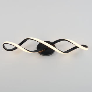 The Artika Swirl LED bathroom vanity light features two intertwined, wave-like LED strips on a round base, finished in modern black, displayed against a plain light gray background.