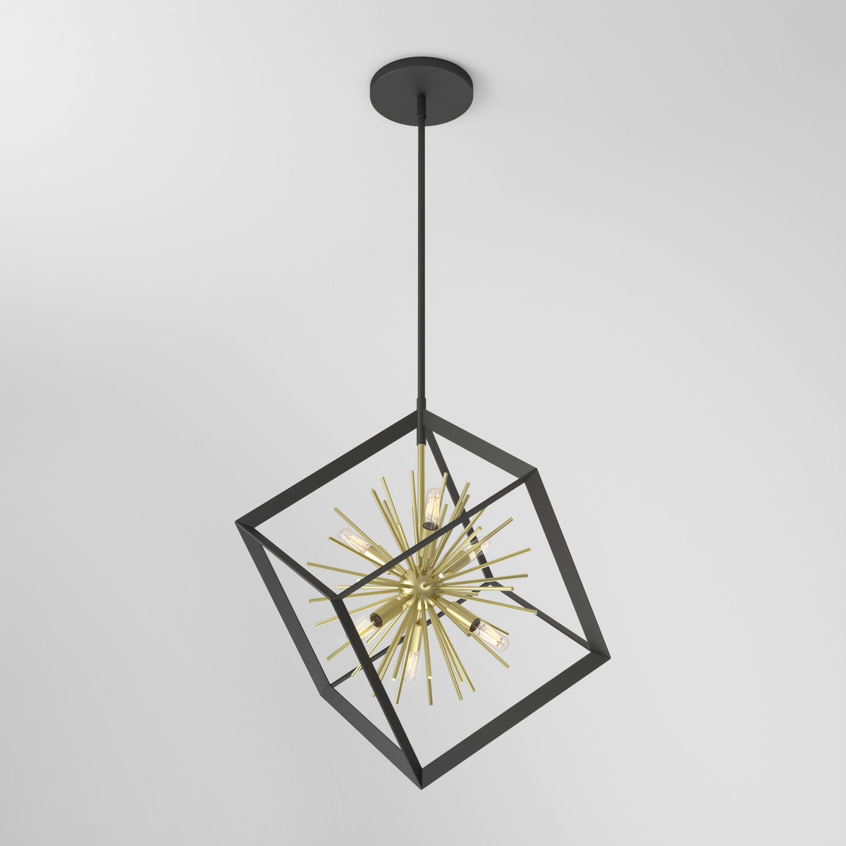 A modern pendant light with a black metal cubic frame surrounds a gold, starburst-style light fixture, hanging from the ceiling against a plain white background.