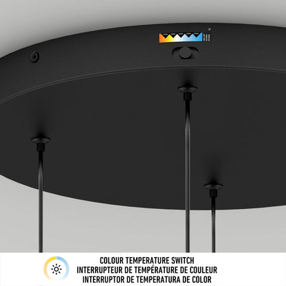 A close-up of the Artika Chorus 4 light LED pendant 5 CCT shows three hanging cords and a color temperature switch labeled from yellow to blue, displaying adjustment options. Below, text in three languages explains the color temperature switch.