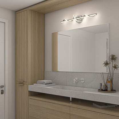 Modern bathroom with light wood cabinets, a large rectangular mirror, Coda modern LED bathroom vanity light by Artika, minimalist wall-mounted faucet, and decorative dried flowers in a vase on a gray stone countertop. Folded towels sit neatly by the sink.