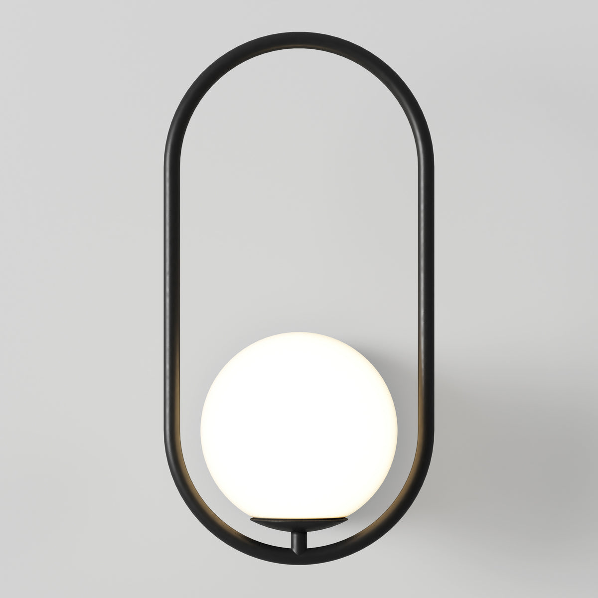 A modern wall sconce with a black oval frame encircling a glowing white spherical light bulb, mounted on a plain light gray wall.