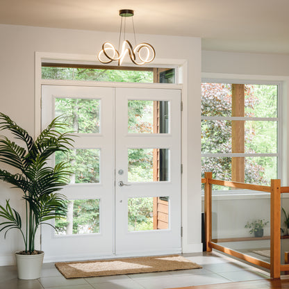Modern entryway with a white door, glass panels, beige rug, indoor plant, and Artika Swirl Ribbon LED pendant overhead.