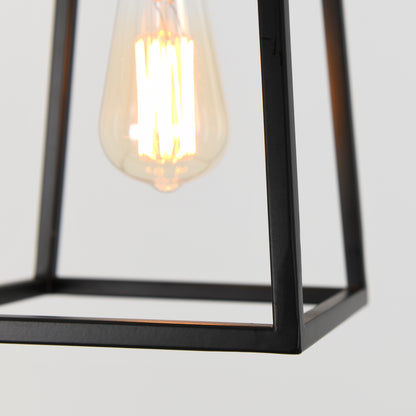 The Artika Carter 1-light pendant features a vintage-style Edison bulb in a black metal geometric frame, shown illuminated against a plain light background.