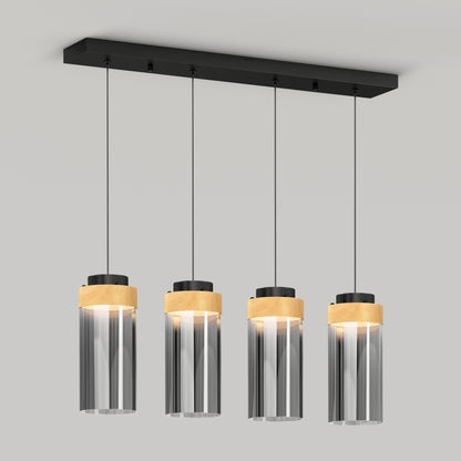 The Artika Hanson 4-light LED pendant features four clear cylindrical glass shades with wooden accents, suspended from a rectangular black base, and offers selectable color temperatures (5 CCT) for a modern ceiling lighting solution.