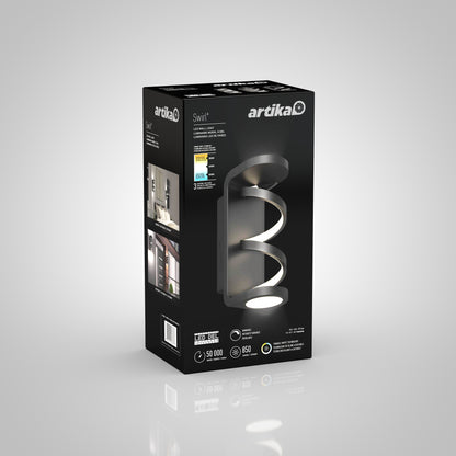 A black and grey box for the Artika Swirl indoor-outdoor LED wall light, featuring an image of the modern curved fixture plus details like energy savings, 50,000-hour lifespan, and 850 lumens brightness.