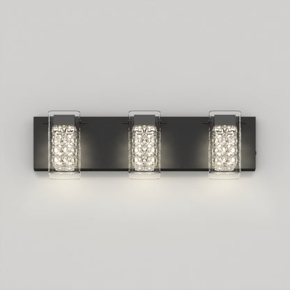 The Artika Crystal Cube LED bathroom vanity light 5 CCT is a modern black wall sconce featuring three textured rectangular crystal glass shades mounted on a flat black base against a light gray wall.