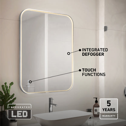 A modern bathroom with a rectangular LED-lit mirror. Labels point to integrated defogger and touch functions. A sink, faucet, and soap dispenser sit below. Icons show Integrated LED and 5 Years Warranty.