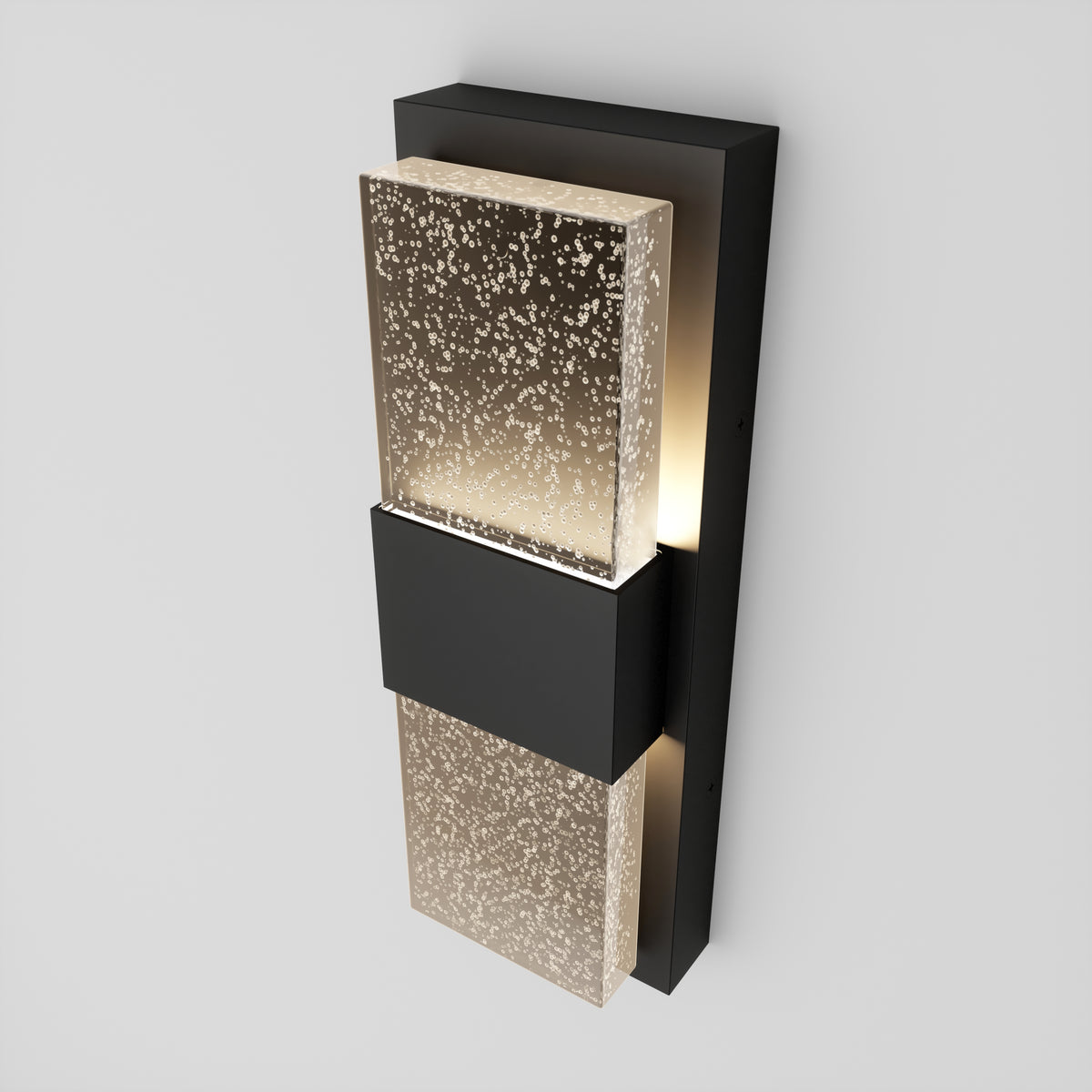 The Artika Mazza Bubble indoor-outdoor LED wall light features two vertically mounted, speckled glass panels on a black rectangular base, illuminating from behind for a modern touch.