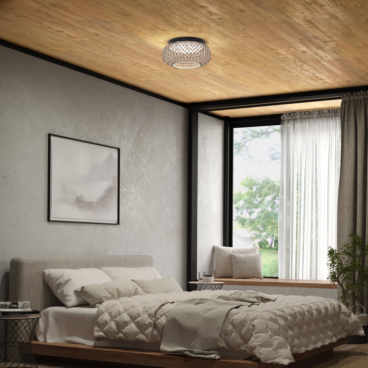 A cozy bedroom with a beige bed, quilted bedding, a large window with curtains, a potted plant, framed landscape art on the wall, and an Artika Benson 15 in. LED flush mount light 5 CCT on the wooden ceiling.