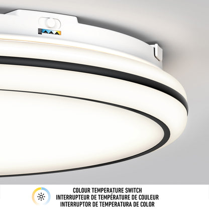 Close-up of Artika’s Emina 13 in. LED flush mount light with 3 CCT color temp switch and labeled control panel. Text below reads “Colour Temperature Switch” in English, French, and Spanish. Outputs 800 lumens.
