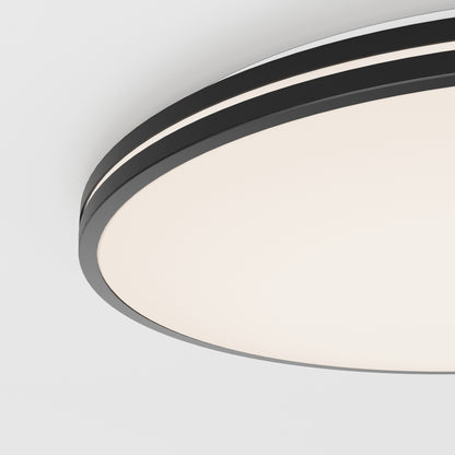 Close-up of the Artika Athos 21 in. LED flush mount light with remote, featuring a modern circular design, black rim, and white illuminated surface, installed on a white ceiling for a minimalist look.