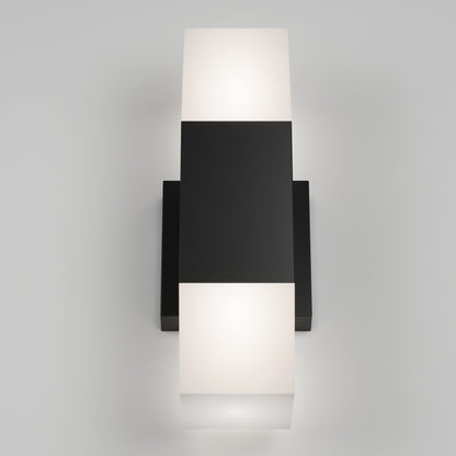 The Artika Lennox indoor-outdoor LED wall light 3 CCT features a black rectangular center and frosted white glass diffusers on both ends, emitting a soft glow from the top and bottom when mounted on a white wall.