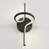A modern wall light fixture with a circular black base and a looping, curved LED light tube that forms a twisting, abstract shape against a plain white wall.