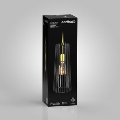 A black rectangular Artika box shows the Gatsby Mini modern mid-century pendant light, featuring a gold socket and a vertical black cage-like shade around the bulb.