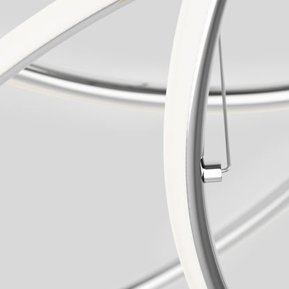 Close-up of the Swirl Butterfly LED contemporary pendant light by Artika, featuring intersecting smooth curved metal rods with a white and silver finish. The sleek, modern design stands out against a light grey background.