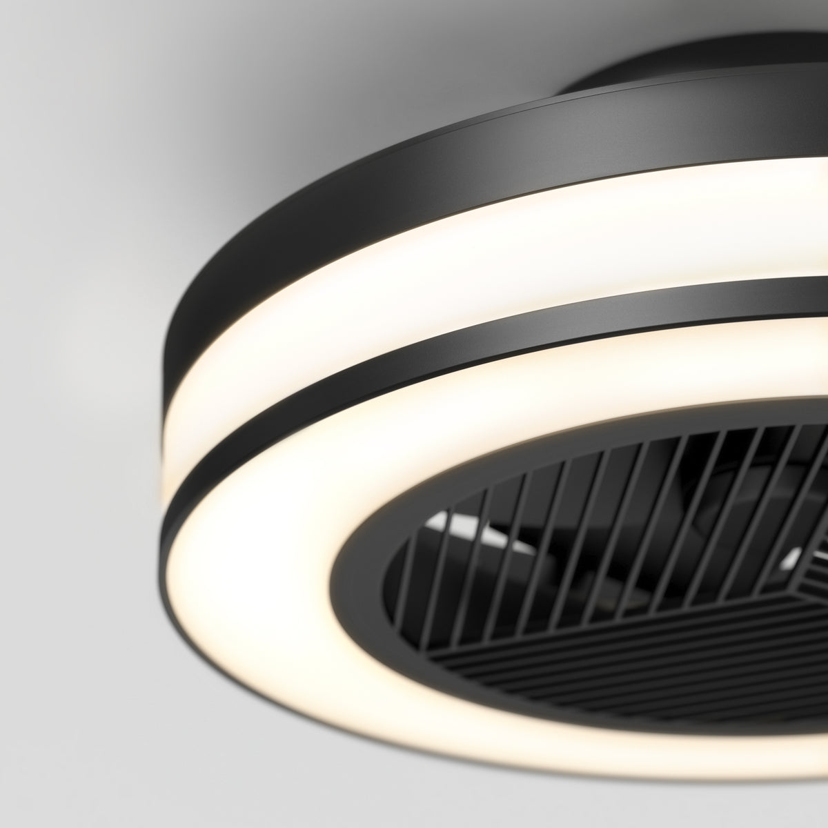 A modern black ceiling fan with a circular LED light, featuring a sleek design and horizontal grille blades, mounted on a white ceiling.