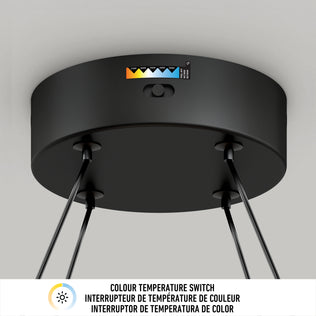The Artika Atrium LED pendant light 5CCT is a black fixture featuring a color temperature switch with an indicator for five settings. A label in English, French, and Spanish explains the color temperature switch.