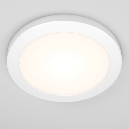 The Artika Europa Disk 7 in. LED modern flush mount light with 3 CCT emits a soft glow against a light gray ceiling in this round, white fixture.