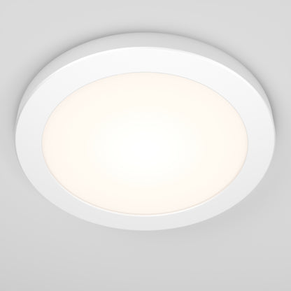 The Artika Europa Disk 7 in. LED modern flush mount light features a minimalistic round white design that emits a soft, even glow against a light gray ceiling, with adjustable color temperatures (3 CCT) for versatile modern lighting.