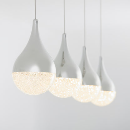 The Artika Glitzer 4-light LED pendant features four modern, teardrop-shaped lights with frosted, sparkling lower halves, hanging in a row against a plain light gray background and glowing softly.