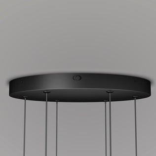 Close-up of the Artika Lewis modern LED pendant light 3 CCT, a round black fixture with multiple adjustable cables and changeable colour temperature, mounted on a plain white ceiling.