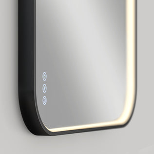 Close-up of the Artika Royce Dimmable LED Mirror, 3 CCT, showing rounded edges and built-in border LEDs. Three touch controls on the lower left offer adjustable color temperature and a defogger. Suitable for horizontal or vertical mounting.